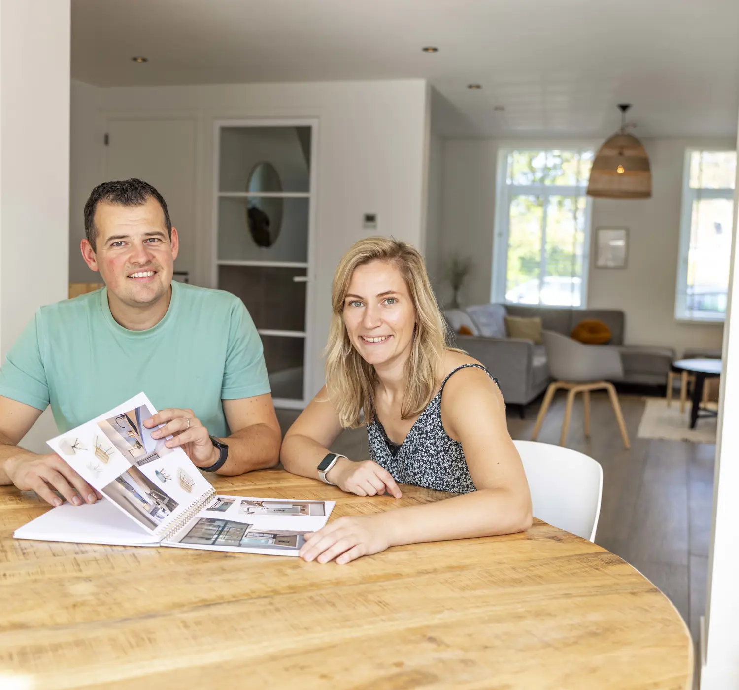 Stel leest magazine aan keukentafel